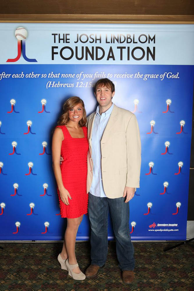 Couple standing in front of a Josh Lindblom foundation background