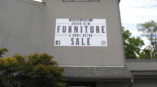 Overstock Cincinnati furniture and home decor sale sign on building