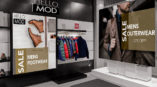 Men’s retail store with jackets hanging next to Hello Mod Mens Footwear & Outerwear signs. 