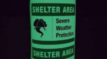 Glow in the dark signage for Shelter Area with thunderstorm icon