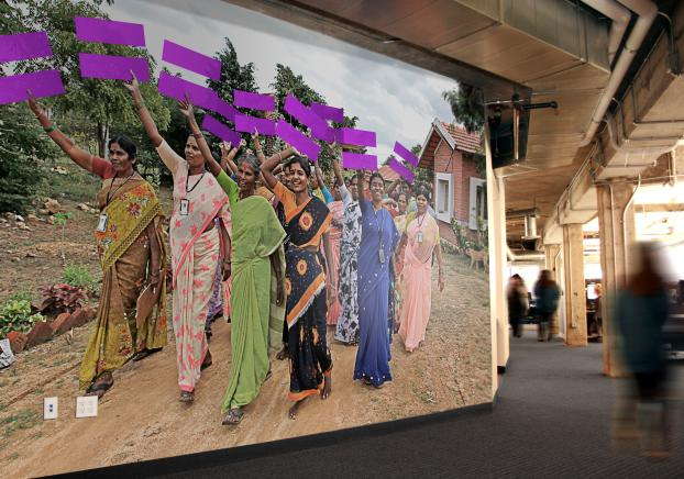 Wall mural of people holding up equality symbols