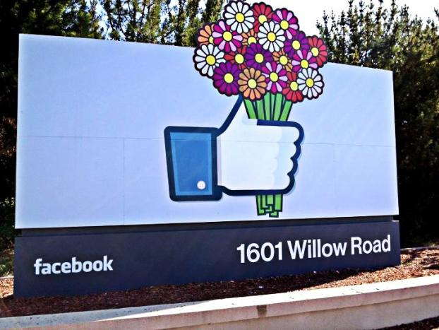 Facebook sign of thumbs up emoji holding flowers