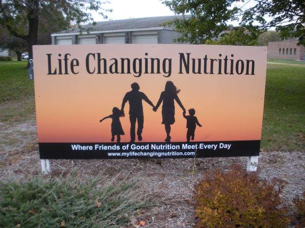 Life Changing Nutrition sign with family holding hands