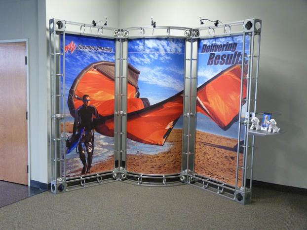 SpeedPro trade show display with person at beach in a wetsuit