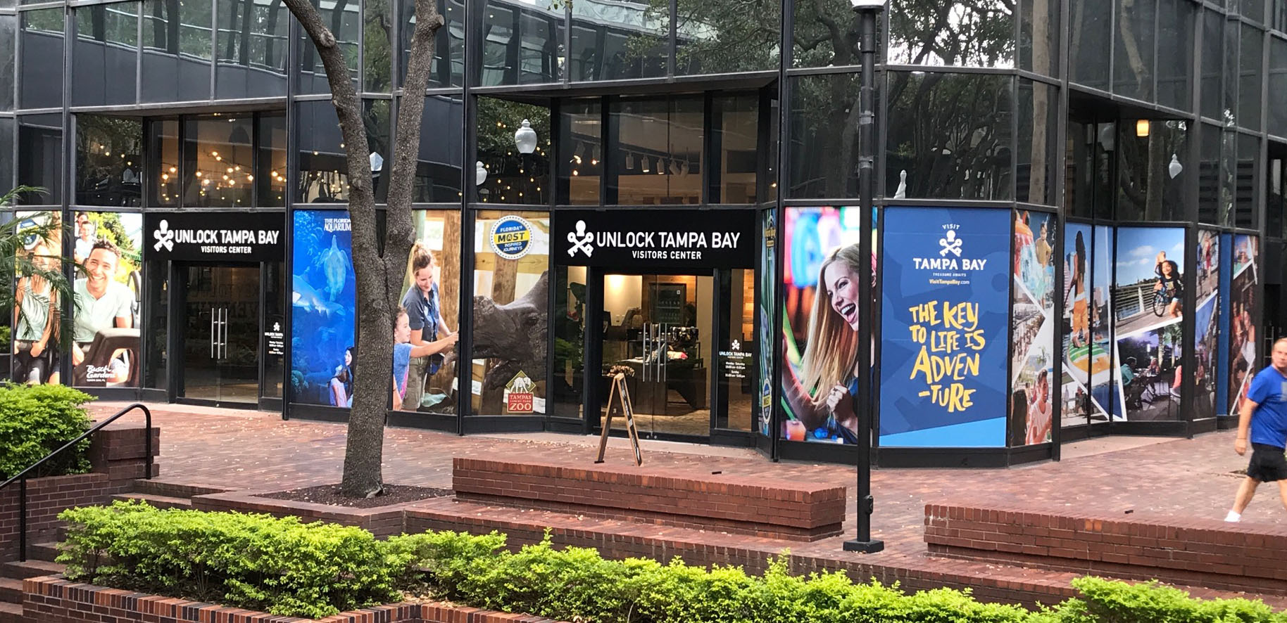 Multiple window graphic banners along the Unlock Tampa Bay Visitors Center